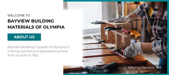 A person wearing gloves works with woodworking clamps on a wooden project. To the left, text reads 'Welcome to Bayview Building Materials of Olympia. About Us. Bayview Building Supplies of Olympia is a family owned and operated business from its start in 1952. Serving Olympia, WA.